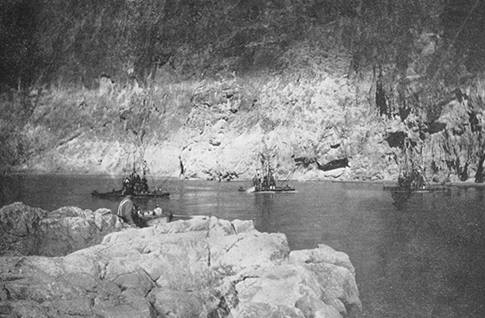 USGS photo, circa 1925. Drilling crew examining bedrock at constricted Boulder Canyon. Note high water scour line 80 feet above low water level.